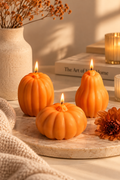 Orange pumpkin shaped candles in a warm neutral Arly Home autumn setting